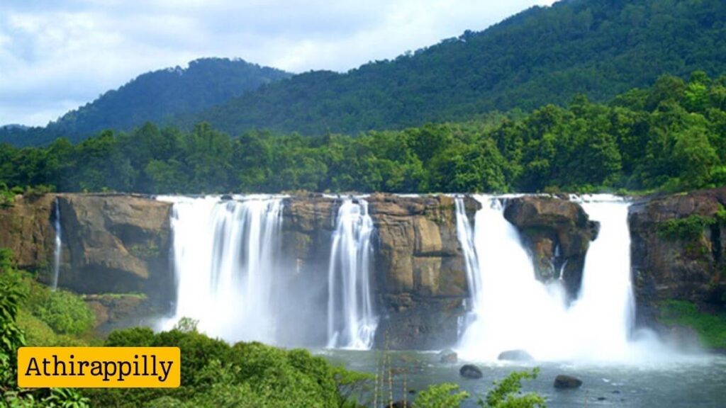 Athirappilly Waterfalls cascading down rocky cliffs surrounded by greenery